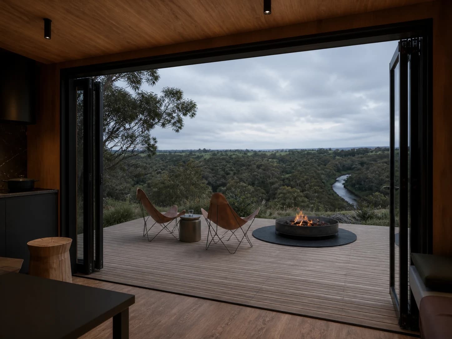 Concept view from inside Tiny House One across the deck and fire pit to the river